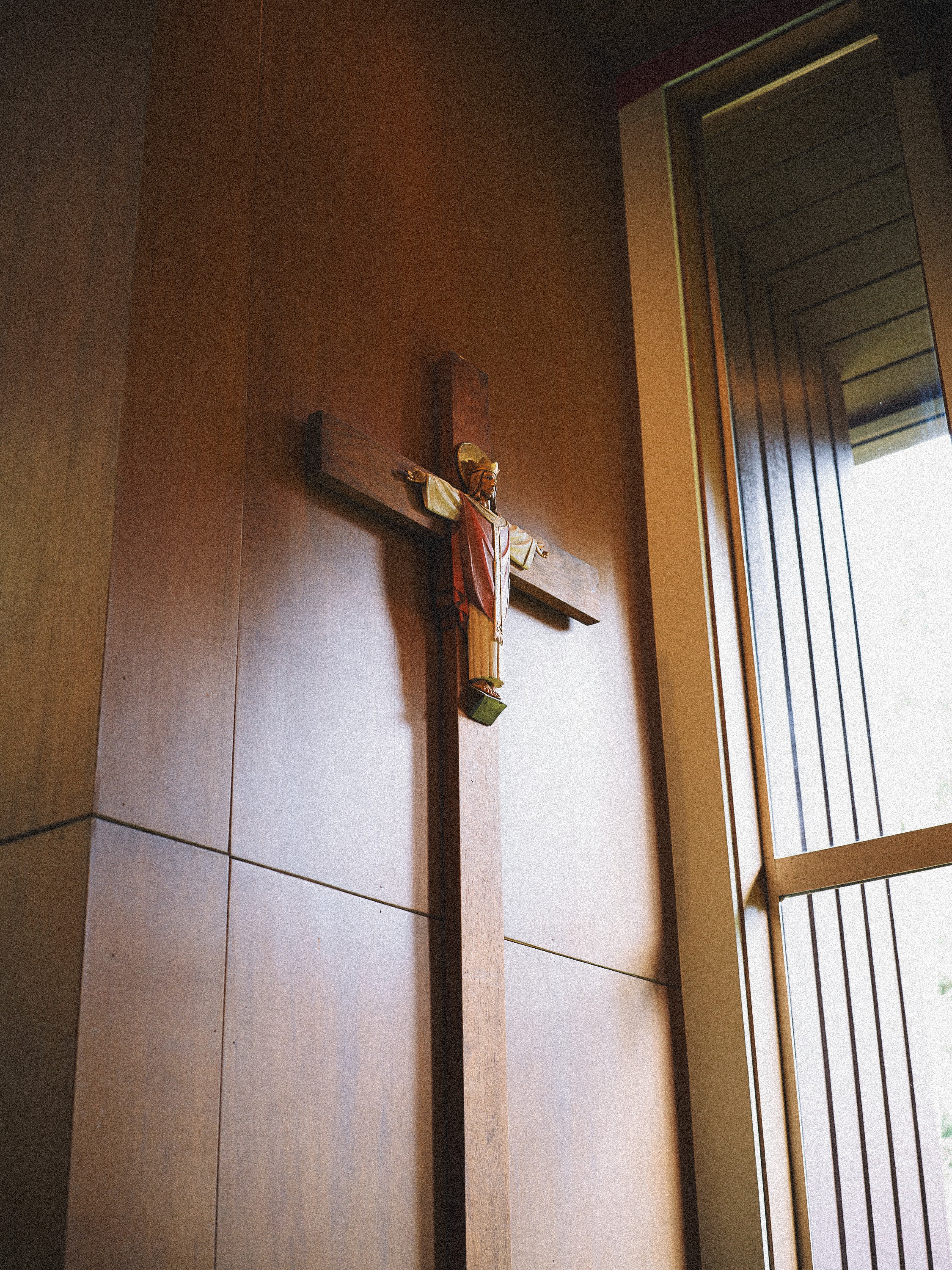 Crucifix on the sanctuary wall in warm light